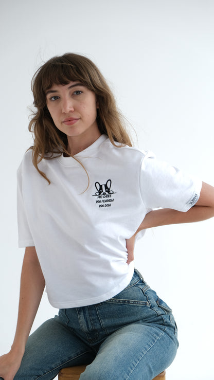 Woman sitting in the white Pro Choice, Pro Feminism, Pro Dogs tee with jeans