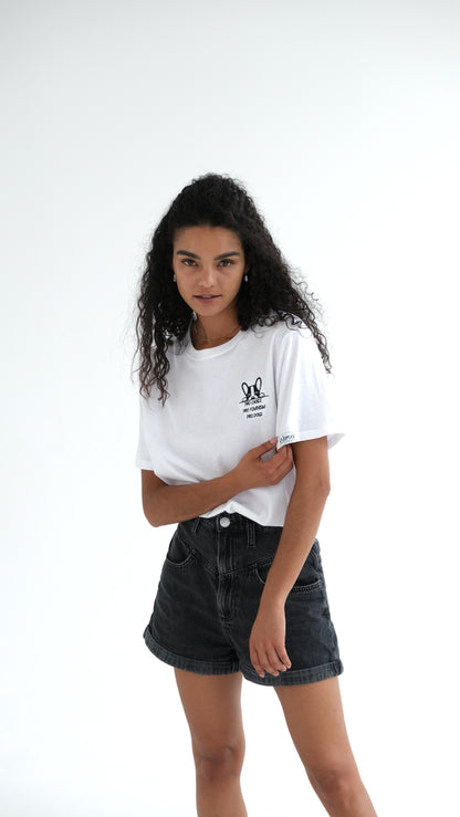 Full length shot of the white Pro Choice, Pro Feminism, Pro Dogs tee worn with black denim shorts