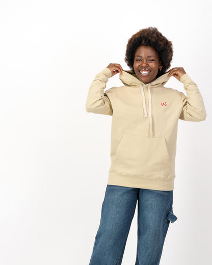 Smiling woman holding the hood of the cream Girls Just Wanna Have Fundamental Human Rights hoodie, front view