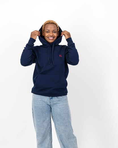 Woman pulling up the hood of the navy Too Clumsy to be Around Fragile Masculinity hoodie, front view