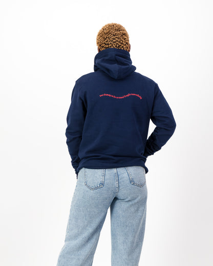 Back view of the navy Too Clumsy to be Around Fragile Masculinity hoodie with the slogan embroidered in pink across the back