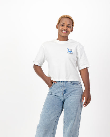 Woman with one hand on her hip in the white Don't Be A Cuntasaurus tee and jeans