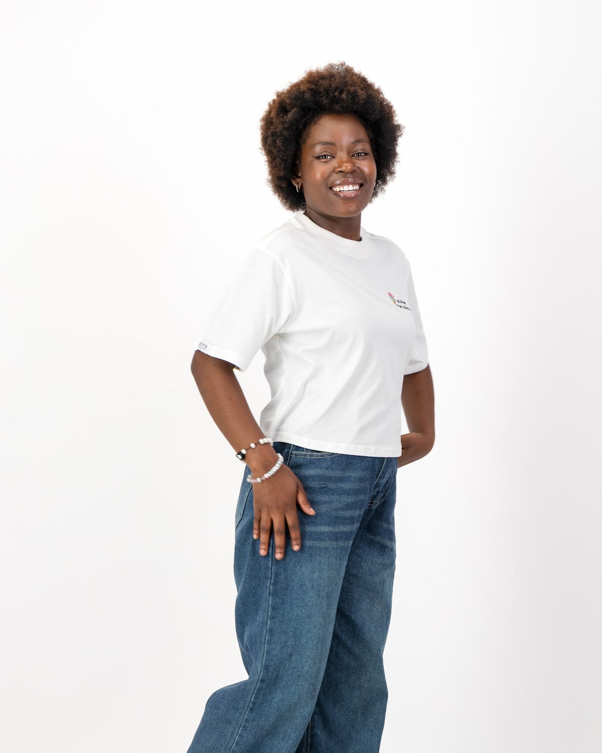 Woman with one hand on her hip in the white I Scream for Equality tee and jeans